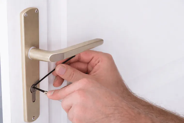 Locksmith working on a door lock in York